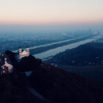 Aerial view of Leopoldsberg's baroque St. Leopold Church perched dramatically on Vienna's highest hill.
