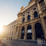 Natural History Museum Vienna at sunset (Naturhistorisches Museum Wien), featuring Renaissance Revival architecture with golden hour lighting and warm glow on classical facade at Maria-Theresien-Platz.