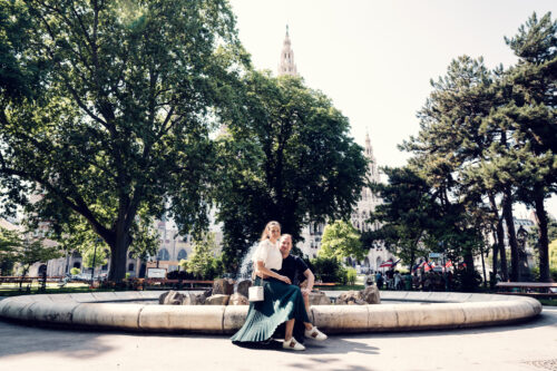 Adriana and Mario posing by the ornate fountain in Rathauspark (Rathauspark Brunnen).