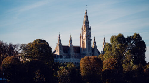 Vienna City Hall (Rathaus) with its tall towers, ornate facade, statues, and pointed arches along the Ringstrasse.