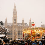 Rathaus Vienna during Christmas market season with festive decorations and lighting.