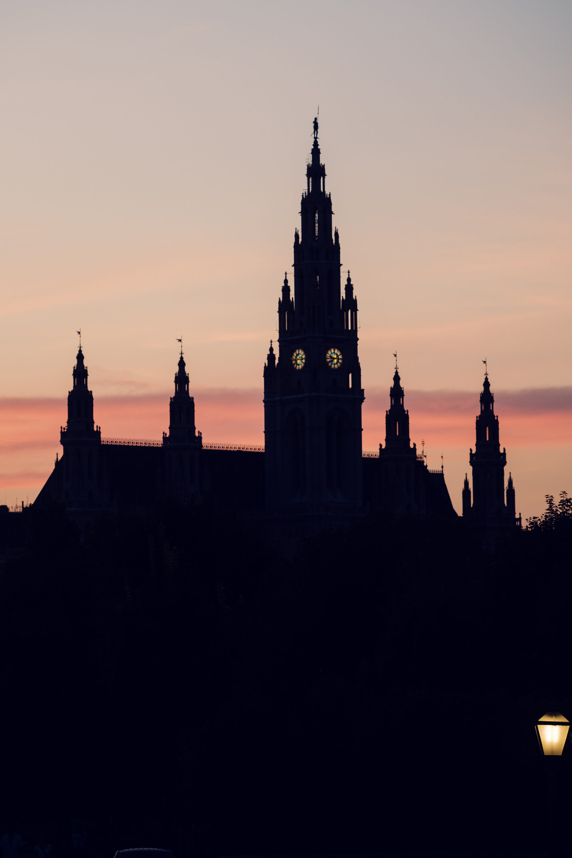 Vienna City Hall (Wiener Rathaus) bathed in warm golden hour light.