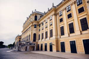 Side view of Schönbrunn Palace (Schloss Schönbrunn), baroque imperial residence with yellow facade and classical windows.
