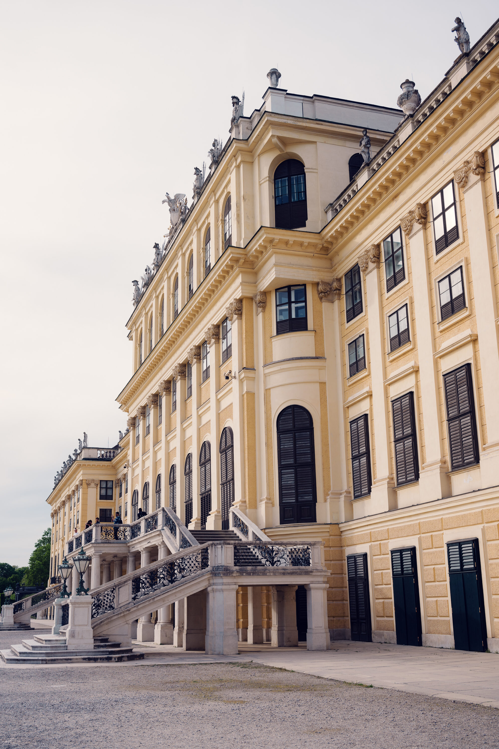 Side view of Schönbrunn Palace (Schloss Schönbrunn), baroque imperial residence with yellow facade and classical windows.