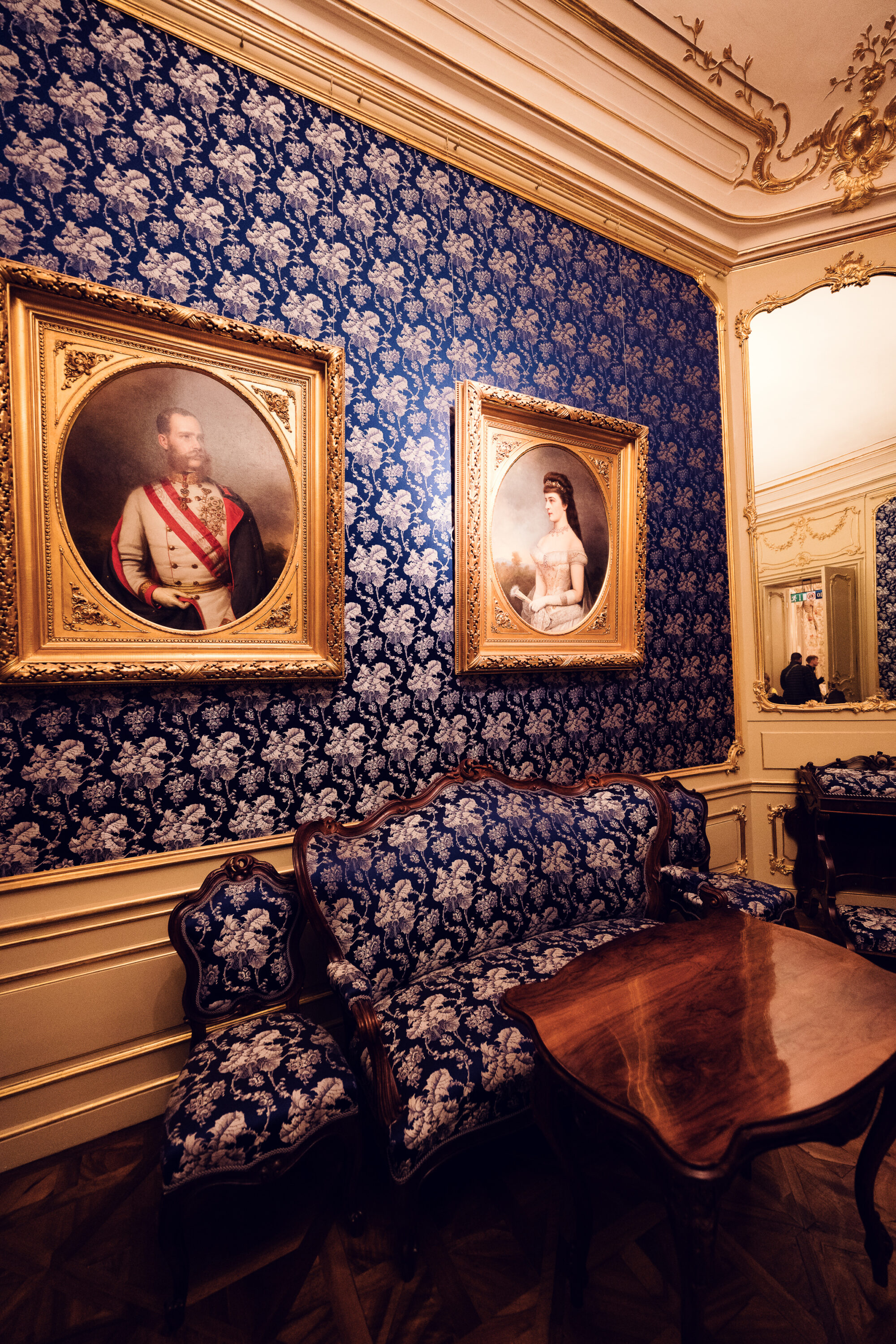 Blue damask wallpaper room at Schönbrunn Palace (Schloss Schönbrunn) with oval portrait paintings.