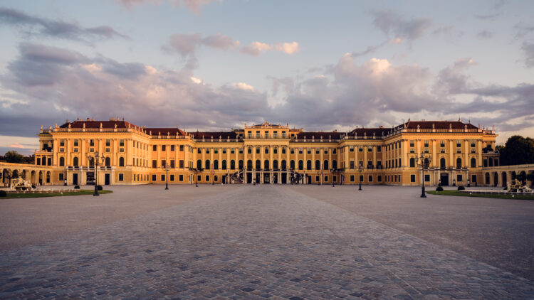 Exterior view of Schönbrunn Palace main building, baroque Austrian imperial palace with characteristic yellow walls.