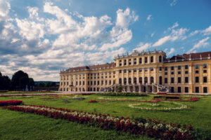 Schönbrunn Palace Schloss Schönbrunn baroque facade with colorful flower gardens in foreground.
