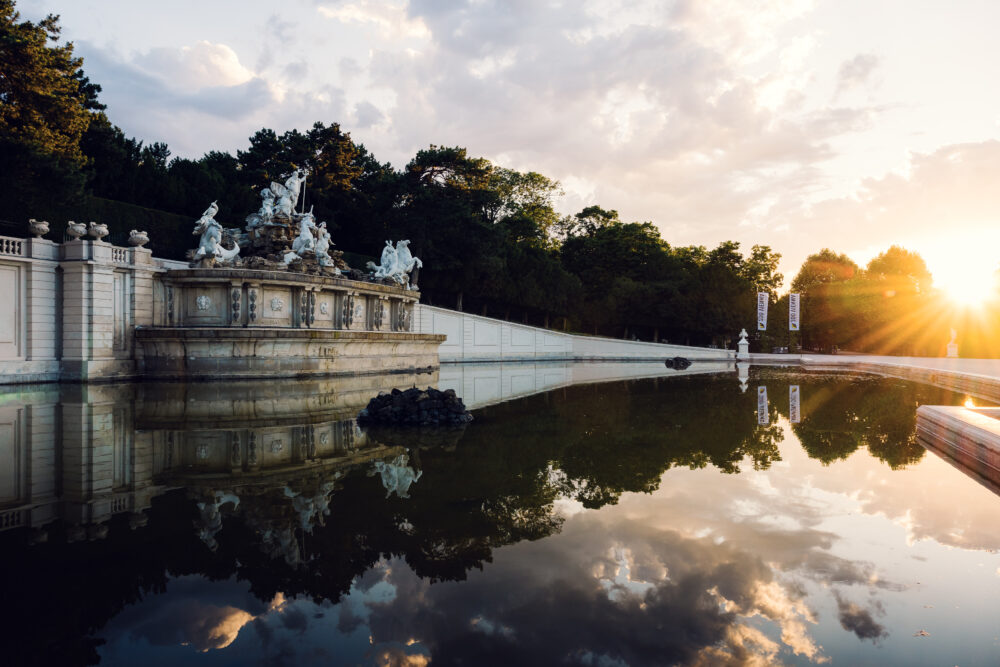 Neptune Fountain at Schönbrunn Palace gardens with baroque sculpture and water features.