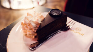 Close-up of the Original Sacher Torte at Café Sacher Bel Étage, showcasing its rich chocolate glaze.