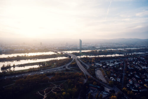 Golden hour light spreading across Vienna seen from the Donauturm observation deck.