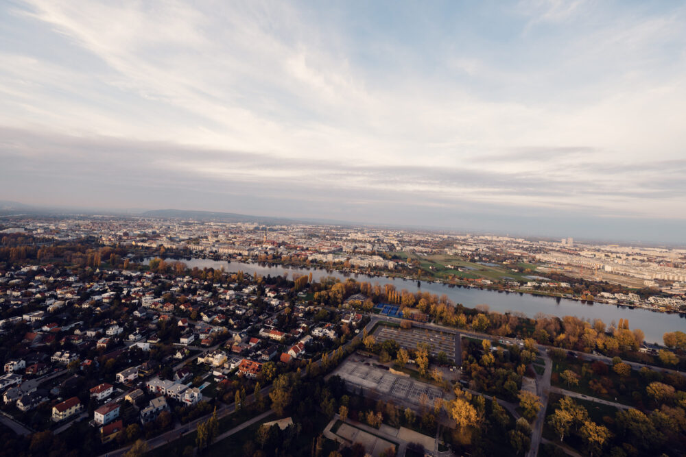 Donauturm Vienna observation deck sunset over Danube River.