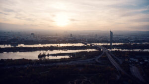 Silhouette of the Donauturm against a golden sunset sky in Vienna.