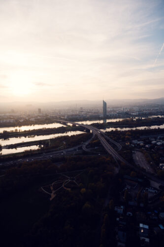 Sunset view from the Donauturm over Donauinsel and Millennium Tower with the Danube and Neue Donau below.