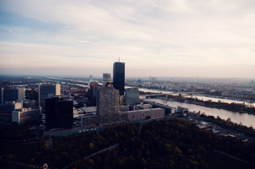 Donauturm Vienna sunset skyscrapers UNO City during golden hour.