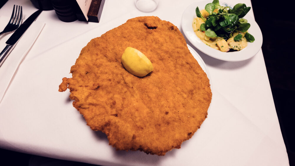 Famous oversized Wiener Schnitzel at Figlmüller Bäckerstrasse, perfectly golden and crispy.