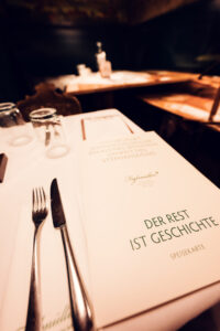 Warm dining room at Figlmüller Bäckerstrasse with guests enjoying authentic Viennese cuisine.