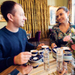 Adriana and Mario enjoying coffee at Gerstner K. u. K. Hofzuckerbäcker, savoring the cozy atmosphere.