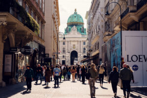 Summer morning at Kohlmarkt, with Hofburg Palace dome creating majestic backdrop for luxury boutiques.