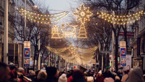 Mariahilfer Strasse Vienna Christmas evening with illuminated holiday decorations festive street lights and seasonal shopping crowds.