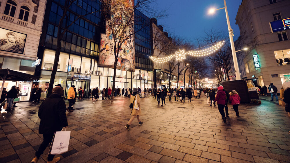Mariahilfer Strasse Wien Christmas shopping scene with holiday decorated storefronts seasonal window displays and festive pedestrian zone Vienna.