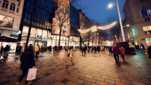 Mariahilfer Strasse Wien Christmas shopping scene with holiday decorated storefronts seasonal window displays and festive pedestrian zone Vienna.