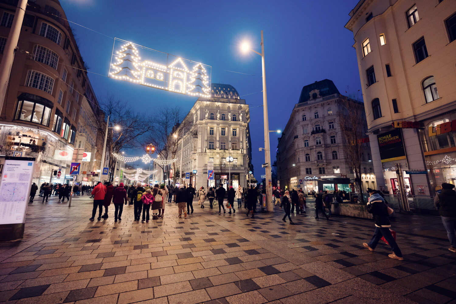 Christmas time on Mariahilfer Strasse Vienna showing holiday window displays festive decorations and Christmas shopping crowds Vienna Austria.