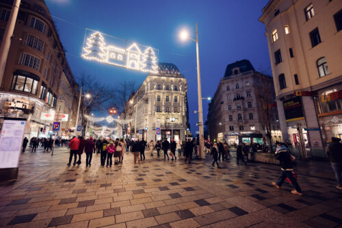 Christmas time on Mariahilfer Strasse Vienna showing holiday window displays festive decorations and Christmas shopping crowds Vienna Austria.