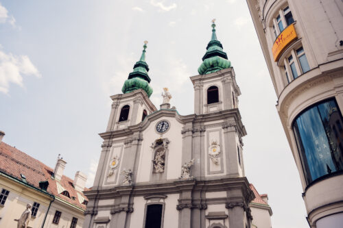 Ornate architecture on Mariahilfer Straße, blending history with modern shops.