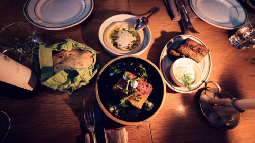 Shared plates and fresh dishes spread across the table at Neni am Prater.