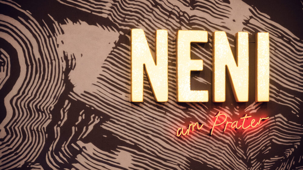 Unique entrance sign of Neni am Prater, reflecting the restaurant's innovative style.