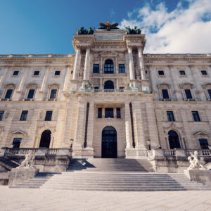 Front entrance of the Neue Burg with its monumental staircase and stone figures.
