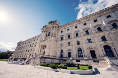 Stunning view of the Hofburg Palace from Burggarten, highlighting its majestic architecture.