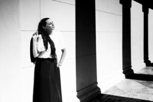 Adriana standing in front of Theseustempel in Volksgarten Vienna on a sunny day.