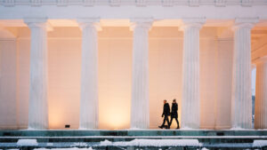 Adriana and Mario on winter night at Theseustempel Vienna with evening lighting and cold weather atmosphere.