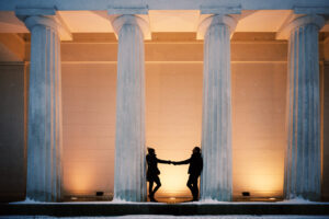 Adriana and Mario at Theseus Temple on a winter night with illuminated columns and frosty atmosphere.