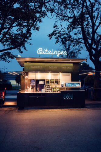 Inviting atmosphere at Bitzinger Würstelstand Prater, where locals and tourists gather to enjoy Vienna's famous sausages.