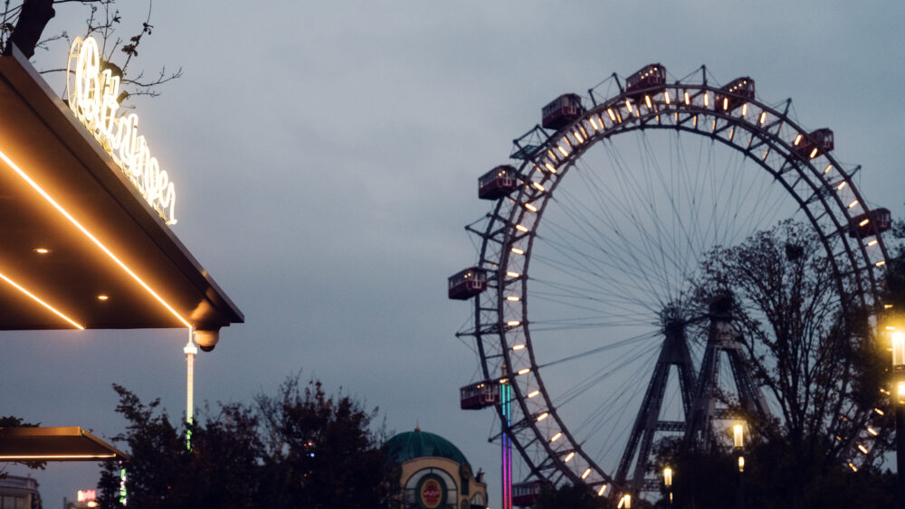 Famous Bitzinger Würstelstand serving traditional sausages, with the majestic Giant Ferris Wheel.
