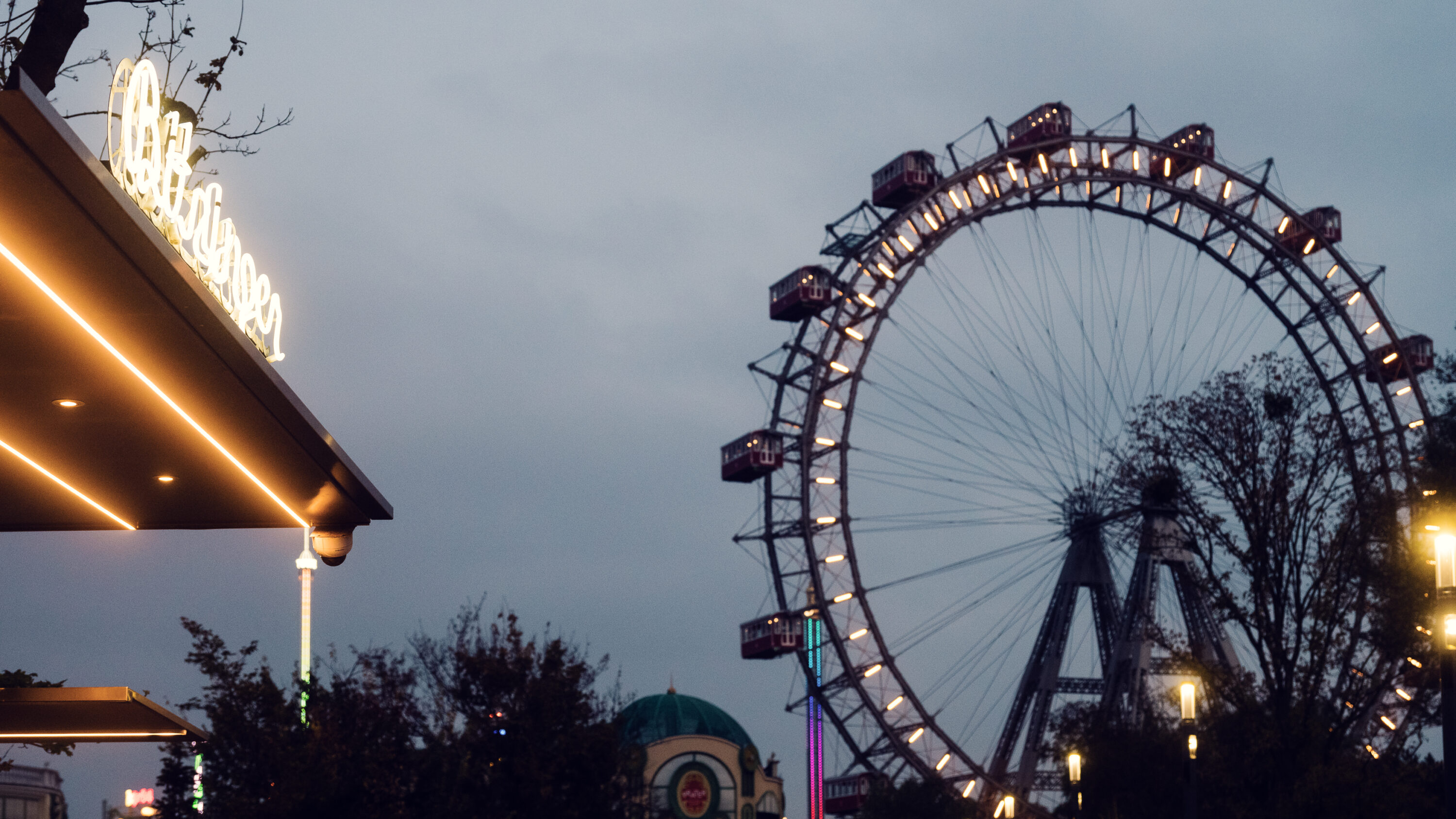 Famous Bitzinger Würstelstand Prater serving traditional sausages, with the majestic Giant Ferris Wheel.