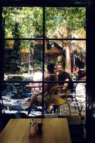 Couple sharing a quiet moment in Café Friedlich's beautiful garden setting.