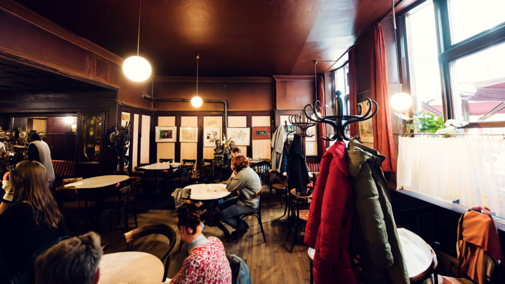 Intimate corner table at Hawelka, where decades of intellectual discourse have polished the wooden surfaces.