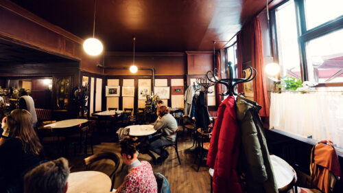 Intimate corner table at Hawelka, where decades of intellectual discourse have polished the wooden surfaces.