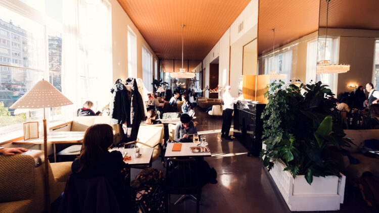 Timeless elegance at Café Prückel, where soft morning light filters through tall windows onto original 1950s furnishings.