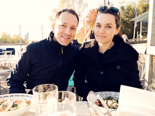 Romantic moment at Das Bootshaus Vienna, where a couple shares an intimate moment on the waterfront terrace.