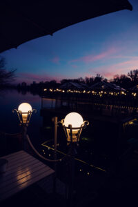 Dinner tables on the Das Bootshaus terrace at sunset along the Alte Donau.