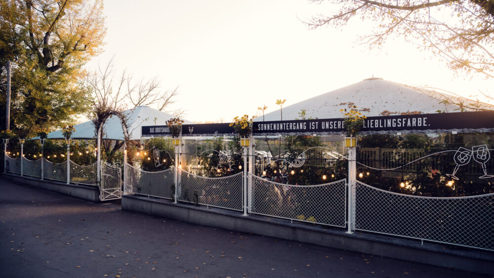 Refined outdoor dining areas at Das Bootshaus, where minimalist design meets waterfront panoramas.