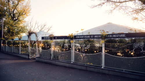 Outdoor dining area at Das Bootshaus with tables along the waterfront.