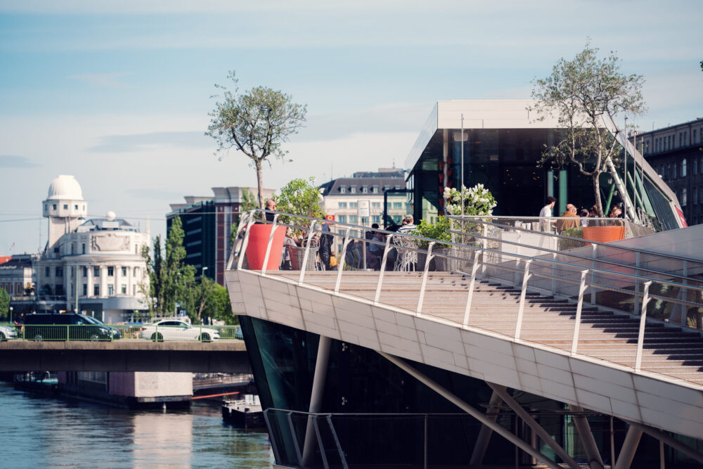 Dynamic angles of Motto am Fluss captured in bright daylight, highlighting its boat-inspired architecture.