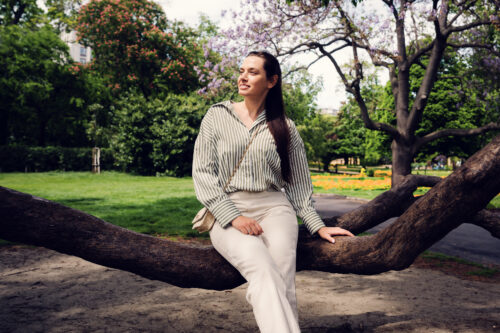 Young woman among Stadtpark's century-old trees.