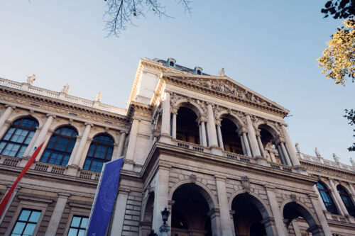 The front of the University of Vienna along the Ringstrasse in soft evening light.