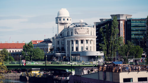 Urania's striking white facade against a bright blue Viennese sky.